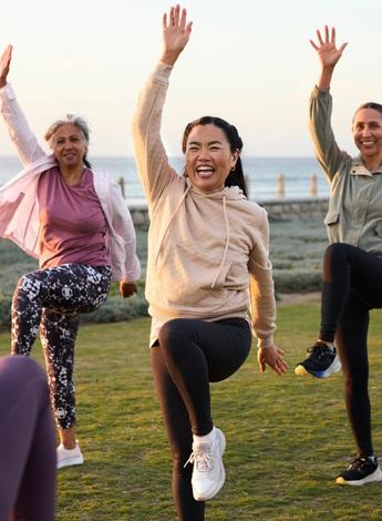 People doing group exercises outside